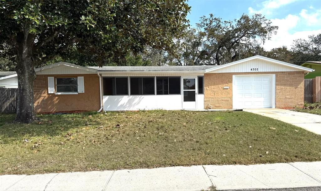 4302 Shoreline Drive New Port Richey, FL 34652 - Photo 1 of 1 a view of a house with a yard