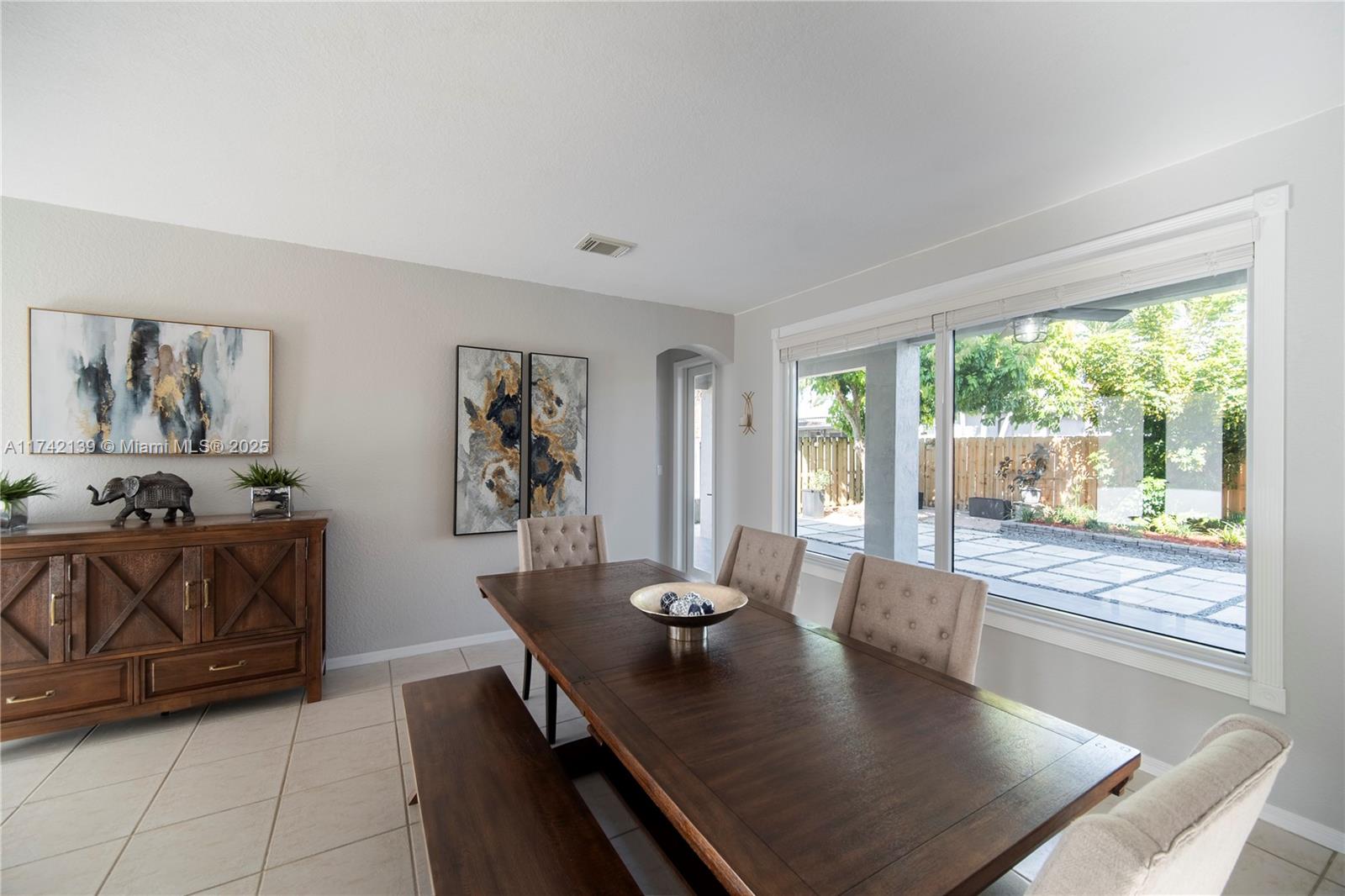 15929 Southwest 141st Terrace Miami, FL 33196 - Photo 11 of 41 a living room with furniture and a large window