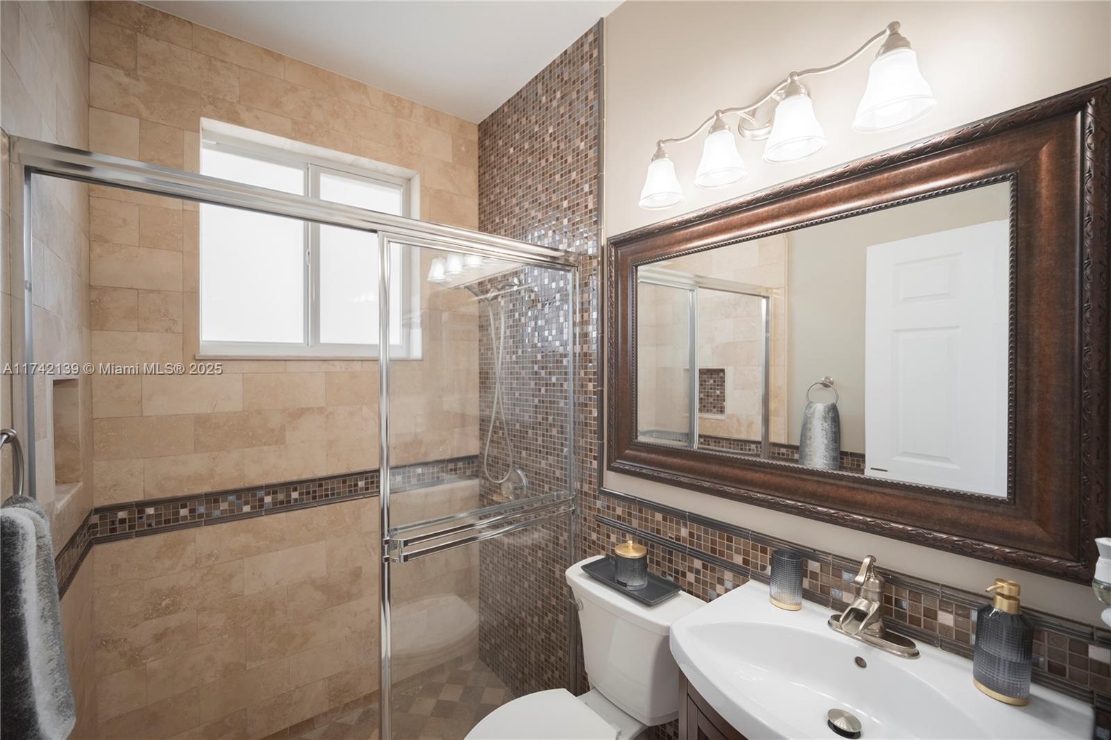 15929 Southwest 141st Terrace Miami, FL 33196 - Photo 12 of 41 a bathroom with a sink mirror and a shower
