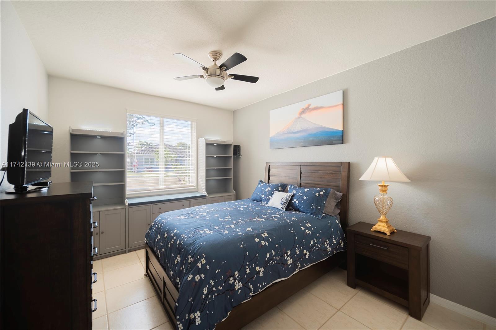 15929 Southwest 141st Terrace Miami, FL 33196 - Photo 13 of 41 a bedroom with a bed and window