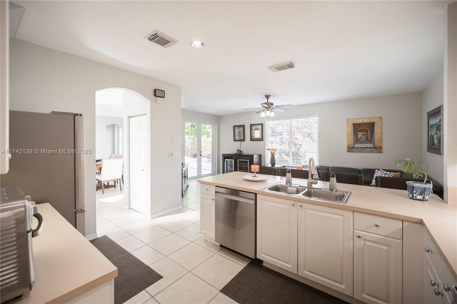 15929 Southwest 141st Terrace Miami, FL 33196 - Photo 15 of 41 a kitchen that has a sink a stove and a refrigerator