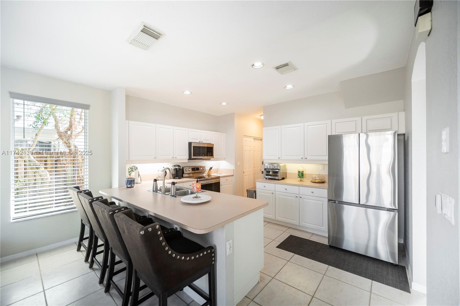 15929 Southwest 141st Terrace Miami, FL 33196 - Photo 16 of 41 a kitchen with appliances a sink and cabinets