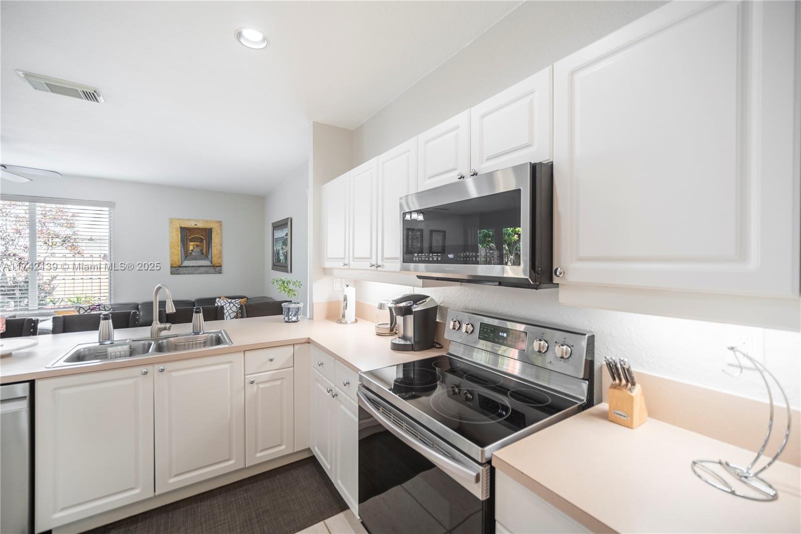 15929 Southwest 141st Terrace Miami, FL 33196 - Photo 17 of 41 a kitchen with a sink stove and microwave