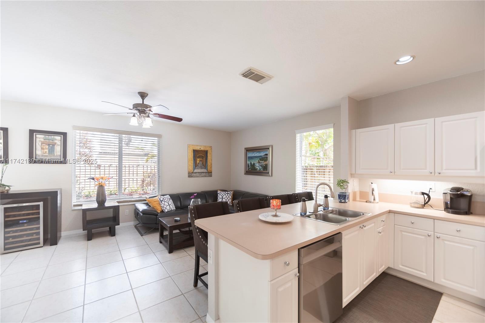 15929 Southwest 141st Terrace Miami, FL 33196 - Photo 19 of 41 a kitchen with a sink dishwasher stove and cabinets