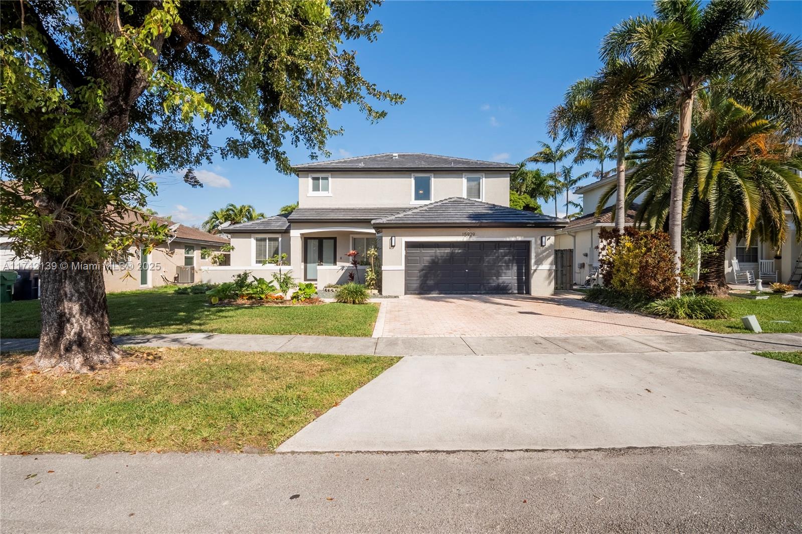 15929 Southwest 141st Terrace Miami, FL 33196 - Photo 2 of 41 front view of house with a yard