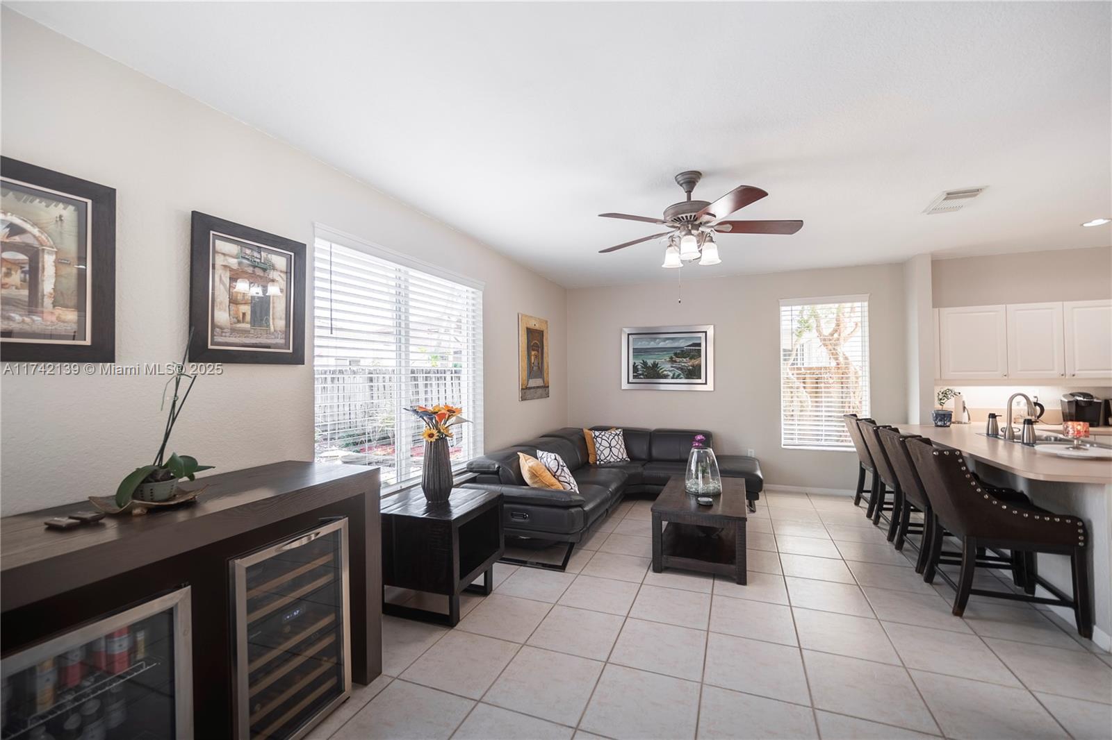 15929 Southwest 141st Terrace Miami, FL 33196 - Photo 21 of 41 a living room with furniture two window and a table