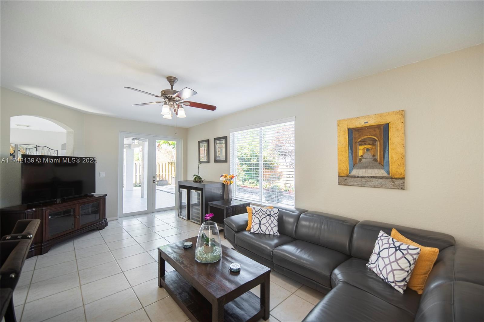 15929 Southwest 141st Terrace Miami, FL 33196 - Photo 22 of 41 a living room with furniture a flat screen tv and a window