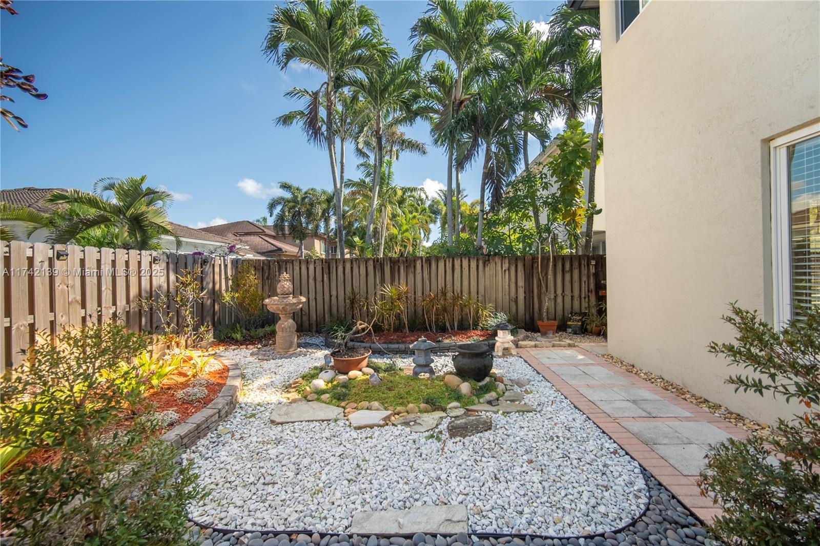 15929 Southwest 141st Terrace Miami, FL 33196 - Photo 27 of 41 a bench is sitting in the middle of a backyard