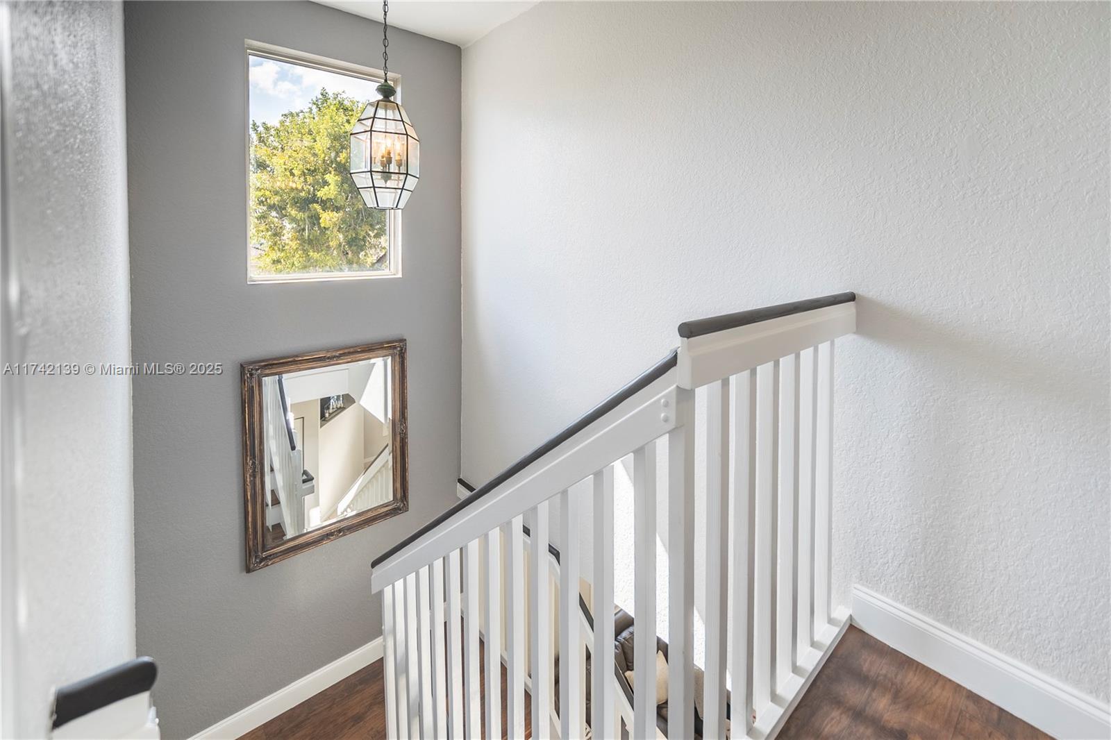 15929 Southwest 141st Terrace Miami, FL 33196 - Photo 29 of 41 a view of entryway with stairs and wooden floor