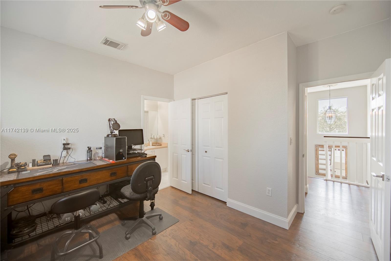 15929 Southwest 141st Terrace Miami, FL 33196 - Photo 34 of 41 a view of a workspace with furniture and wooden floor