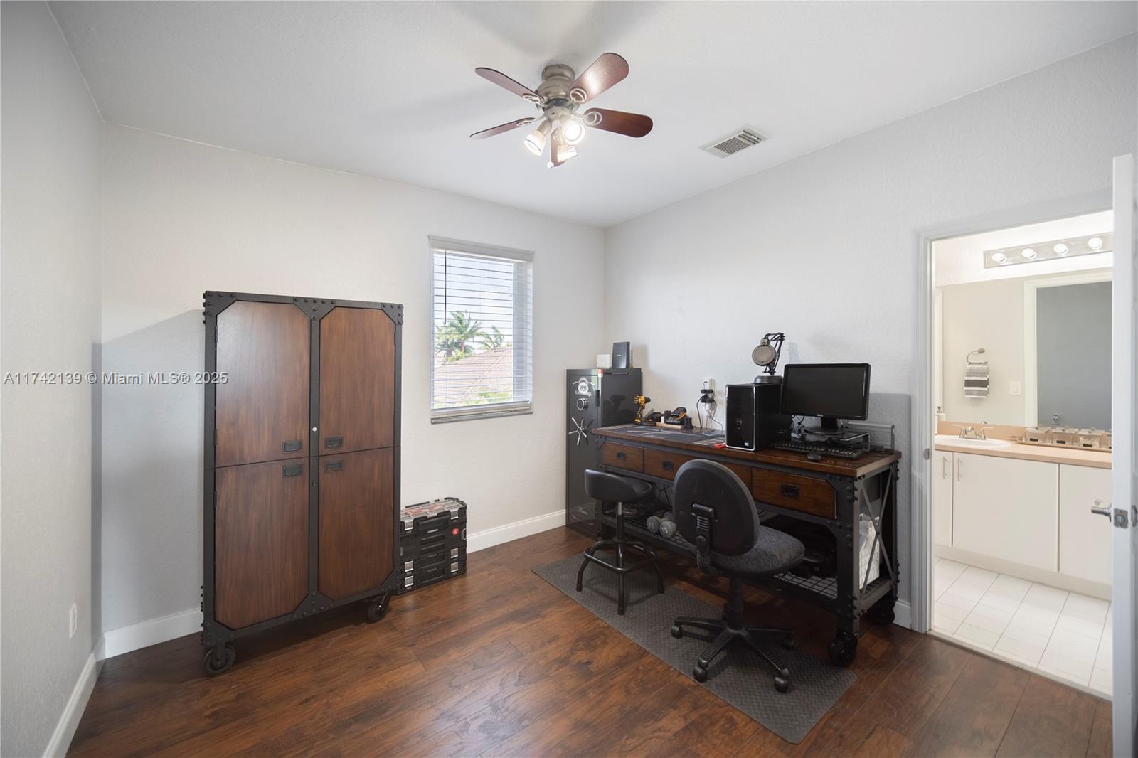 15929 Southwest 141st Terrace Miami, FL 33196 - Photo 35 of 41 a view of a workspace with furniture and a window