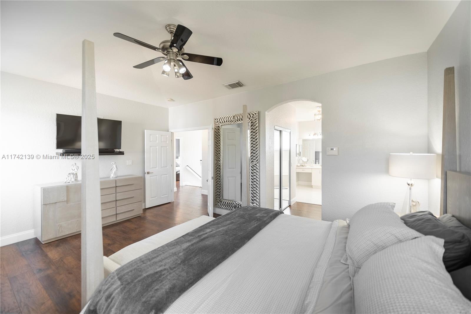 15929 Southwest 141st Terrace Miami, FL 33196 - Photo 37 of 41 a bedroom with a bed and a flat screen tv