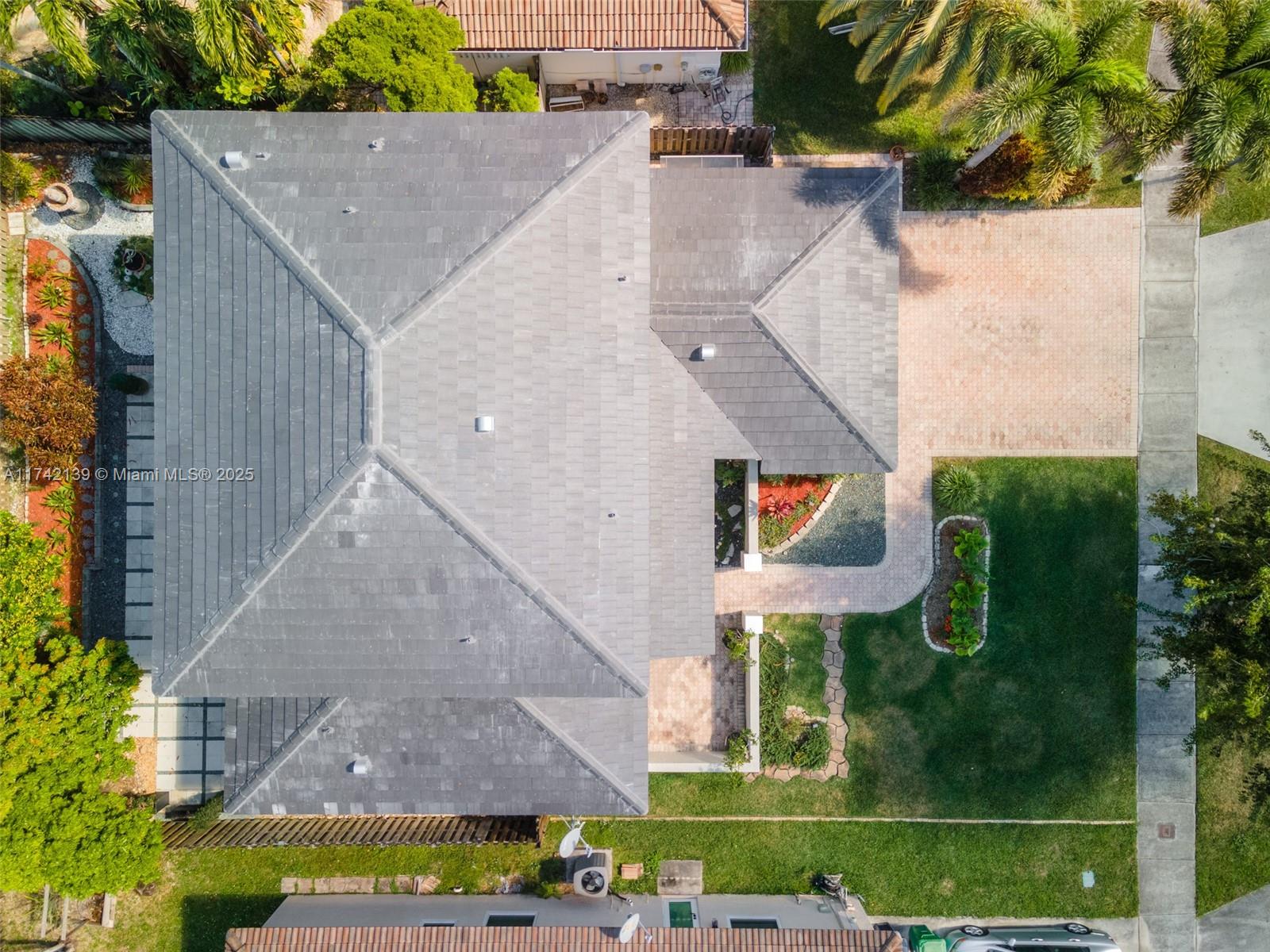 15929 Southwest 141st Terrace Miami, FL 33196 - Photo 4 of 41 an aerial view of a house with a yard and potted plants
