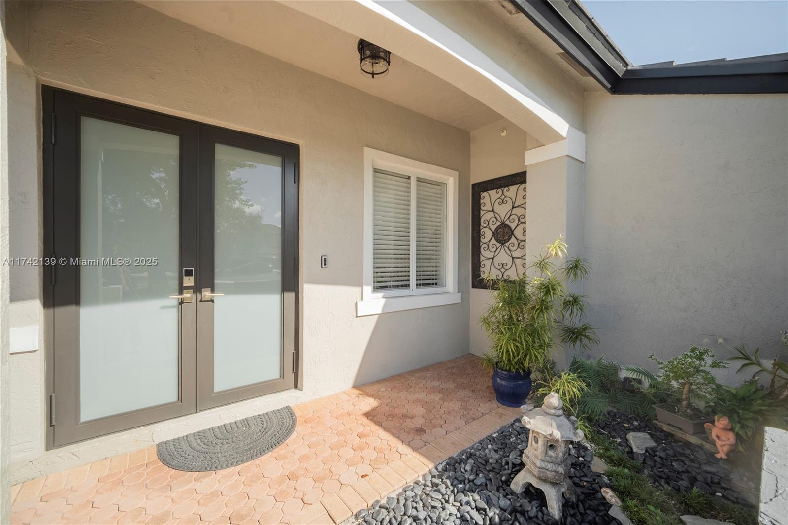 15929 Southwest 141st Terrace Miami, FL 33196 - Photo 5 of 41 a view of a porch with a potted plant