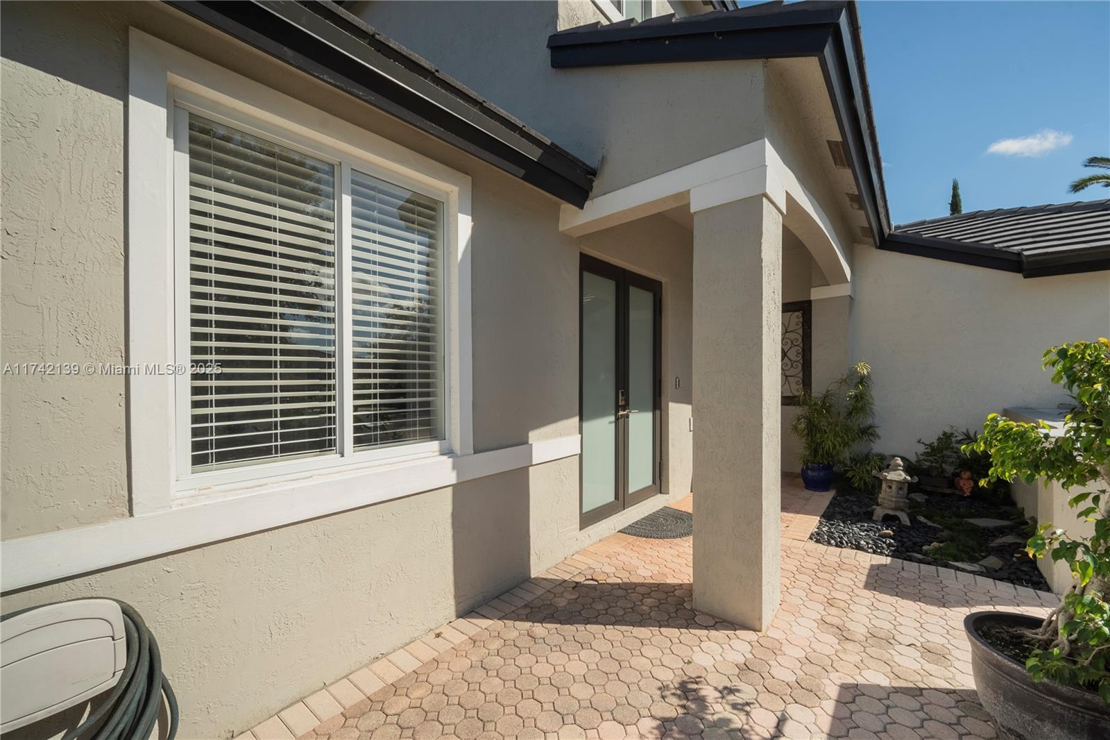 15929 Southwest 141st Terrace Miami, FL 33196 - Photo 7 of 41 a porch with seating space