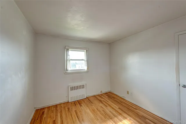 a view of a room with a wooden floor and a window