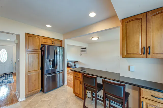 a kitchen with stainless steel appliances a refrigerator and a stove top oven
