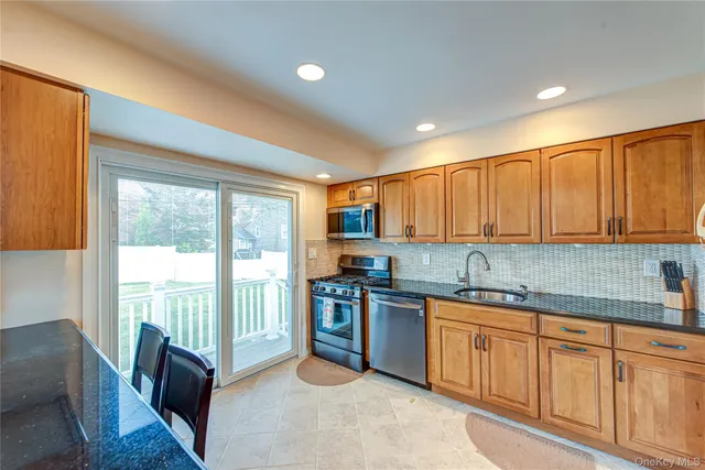 a kitchen that has a sink and a stove top oven