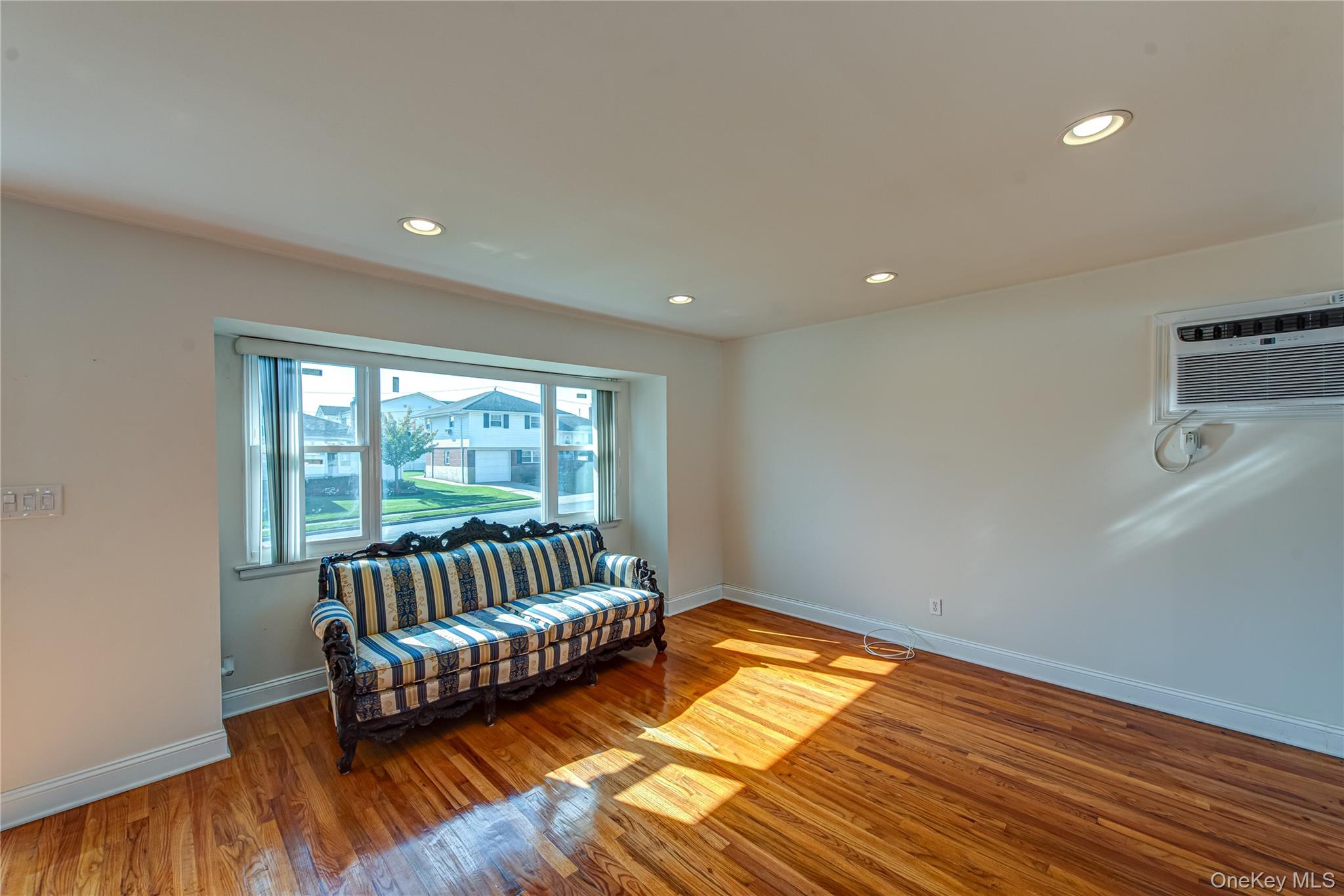49 Spector Lane Plainview, NY 11803 - Photo 8 of 20 a bedroom with furniture and a wooden floor