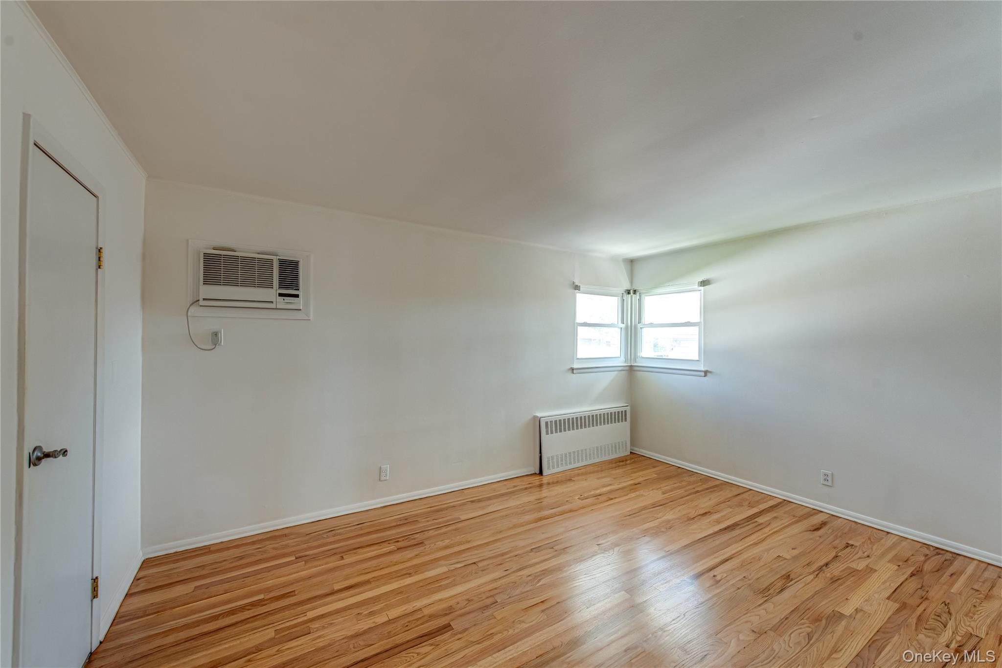 49 Spector Lane Plainview, NY 11803 - Photo 10 of 20 a view of empty room with wooden floor and fan