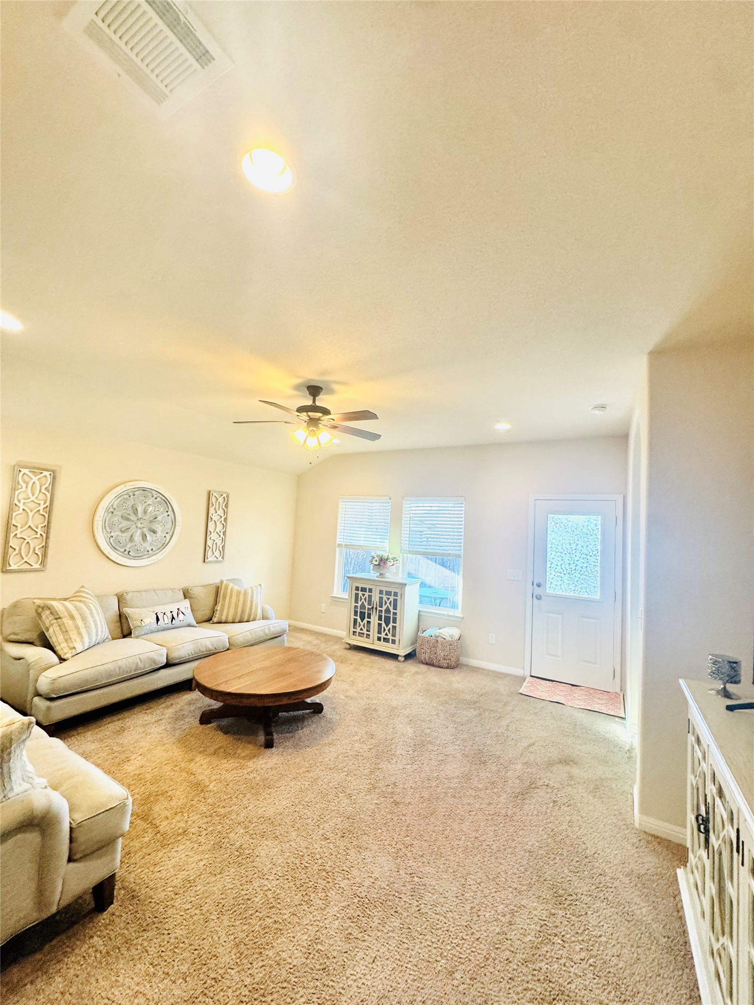 413 Gettysburg Loop Elgin, TX 78621 - Photo 15 of 32 Living room featuring recessed lighting, light colored carpet, and lofted ceiling