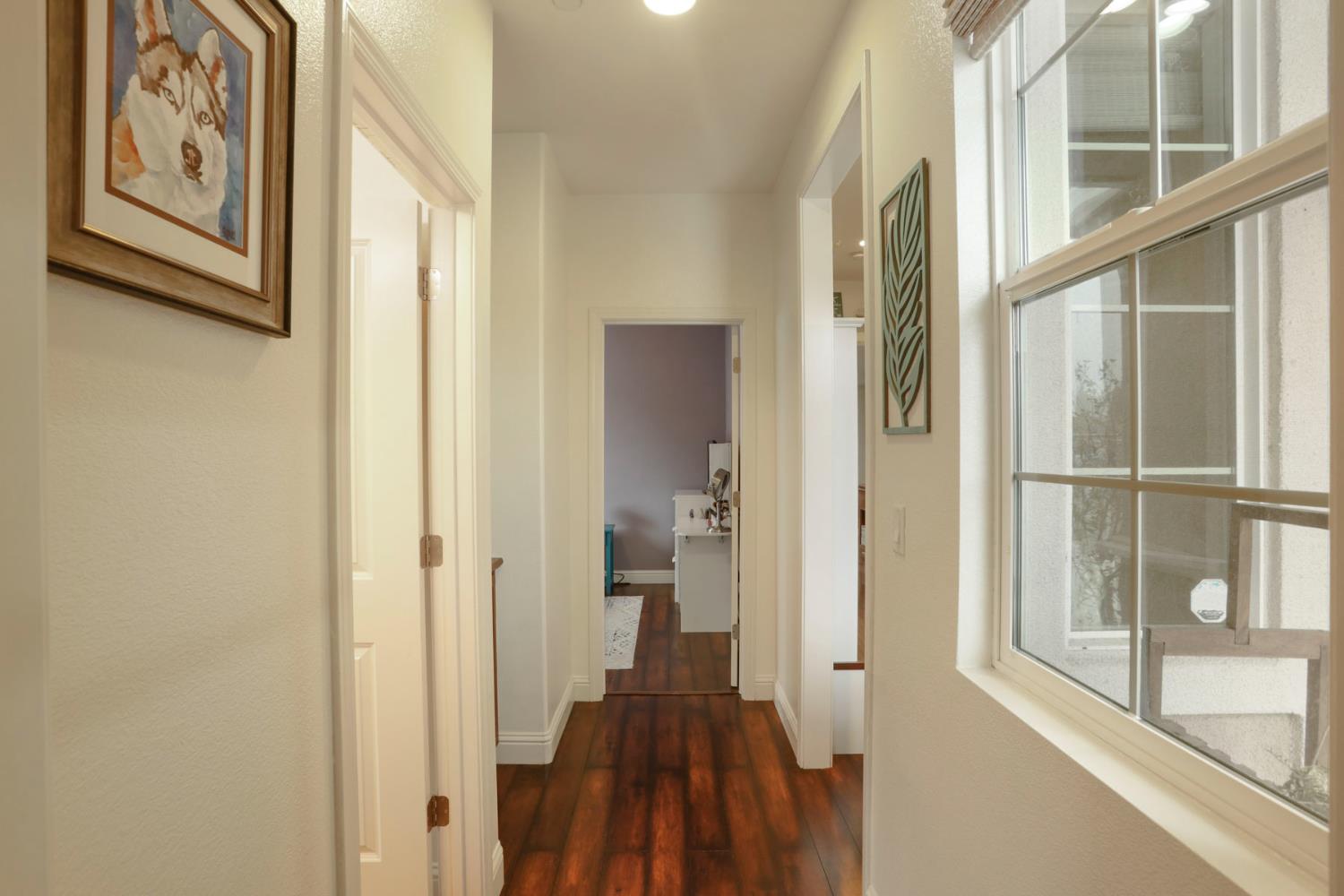 1091 Alba Street Manteca, CA 95337 - Photo 12 of 37 a view of hallway with wooden floor and windows
