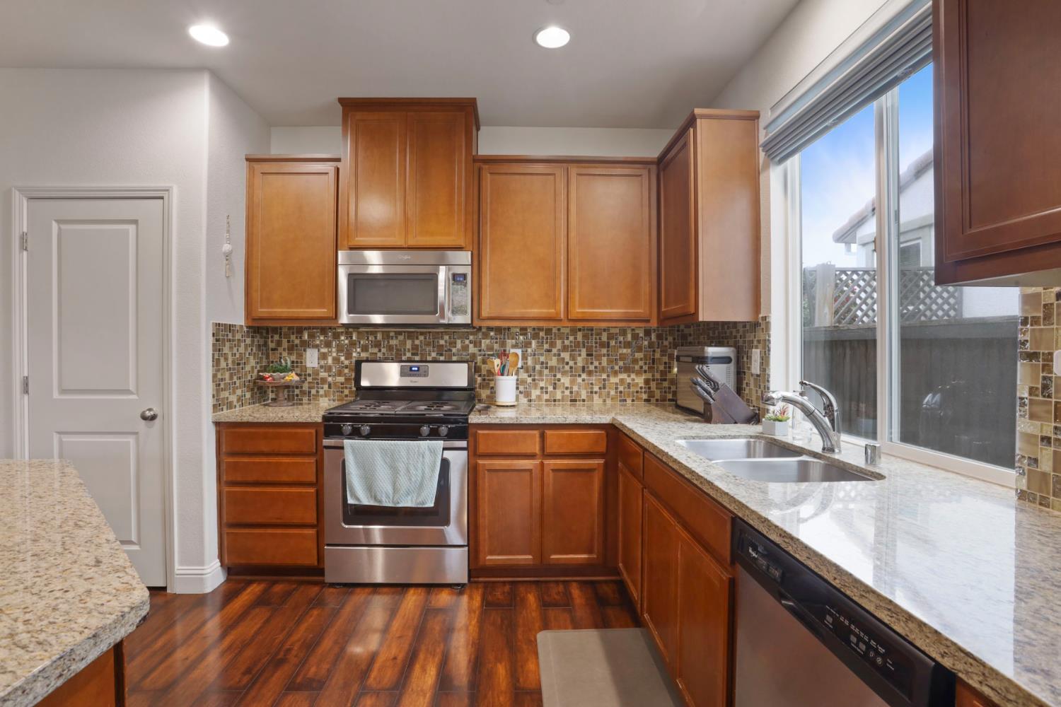 1091 Alba Street Manteca, CA 95337 - Photo 16 of 37 a kitchen with a sink stove and cabinets