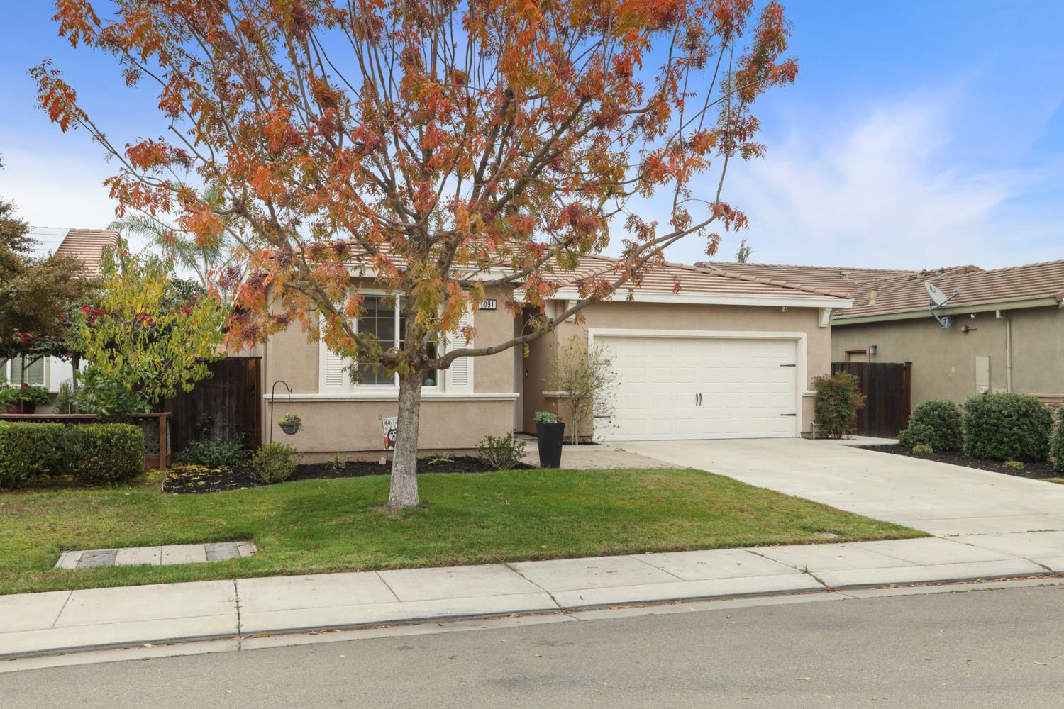 1091 Alba Street Manteca, CA 95337 - Photo 2 of 37 a front view of a house with a yard and garage
