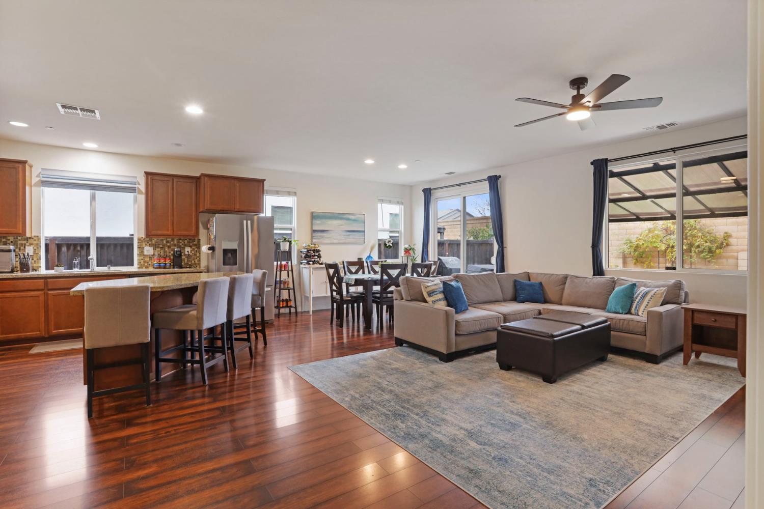 1091 Alba Street Manteca, CA 95337 - Photo 22 of 37 a living room with lots of furniture kitchen view and a large window