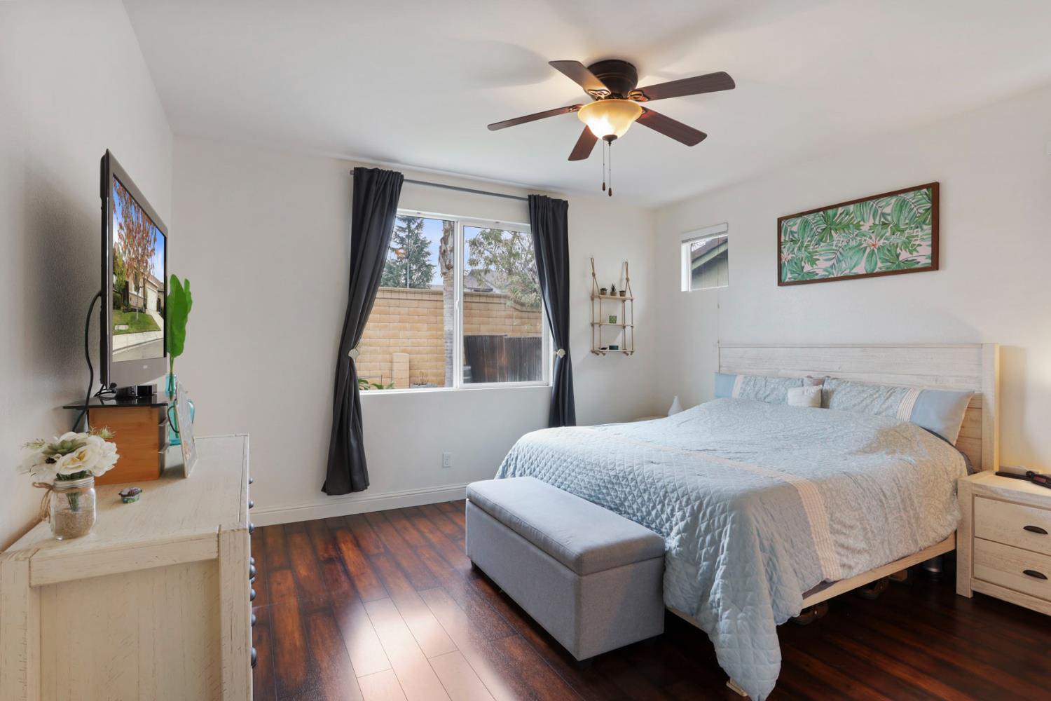 1091 Alba Street Manteca, CA 95337 - Photo 30 of 37 a bedroom with a large bed and a window