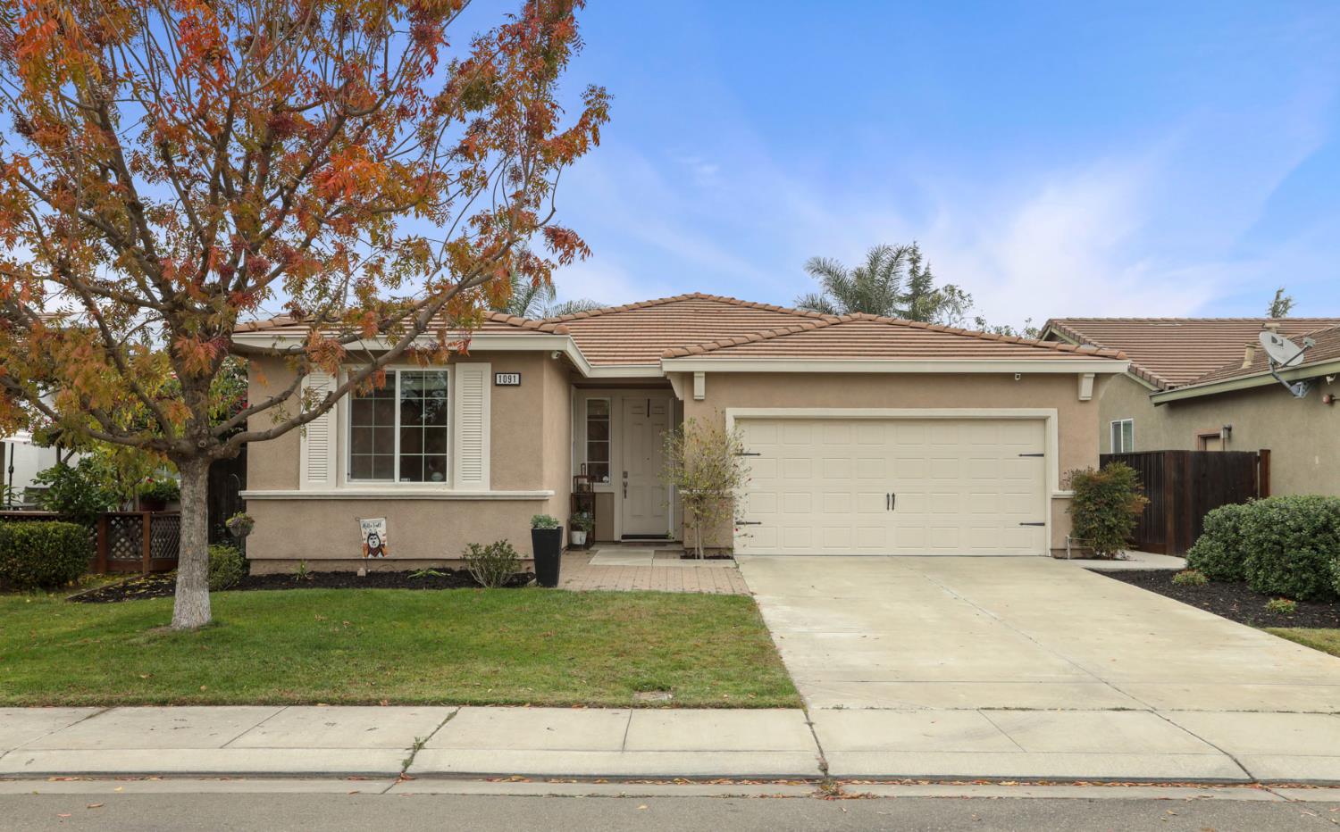 1091 Alba Street Manteca, CA 95337 - Photo 3 of 37 a view of a house with a garden