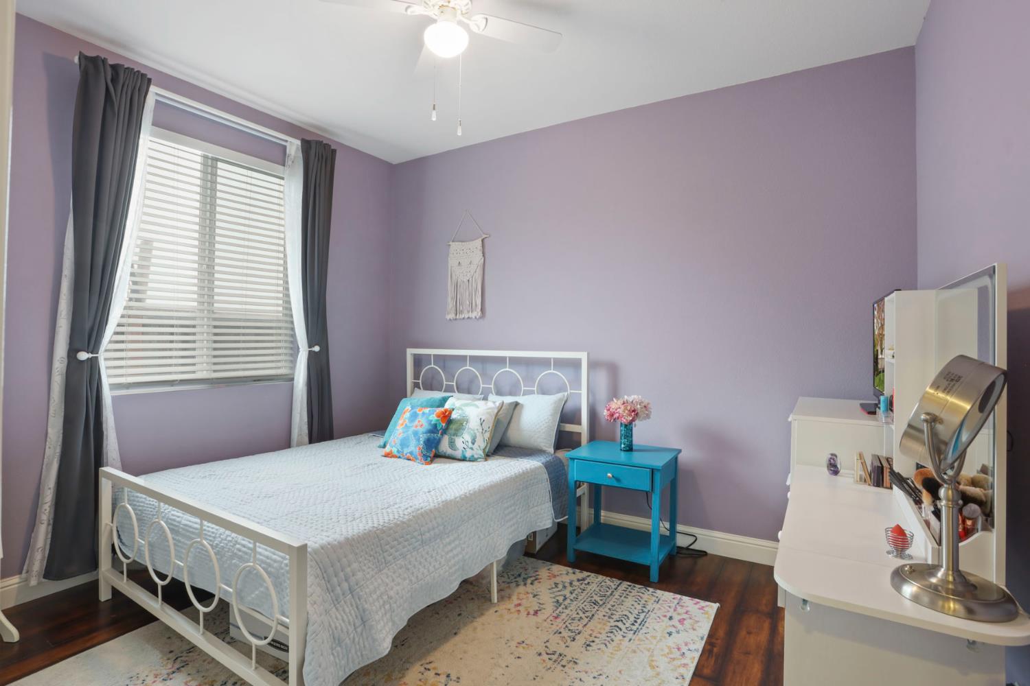 1091 Alba Street Manteca, CA 95337 - Photo 10 of 37 a bedroom with a bed and a table in it
