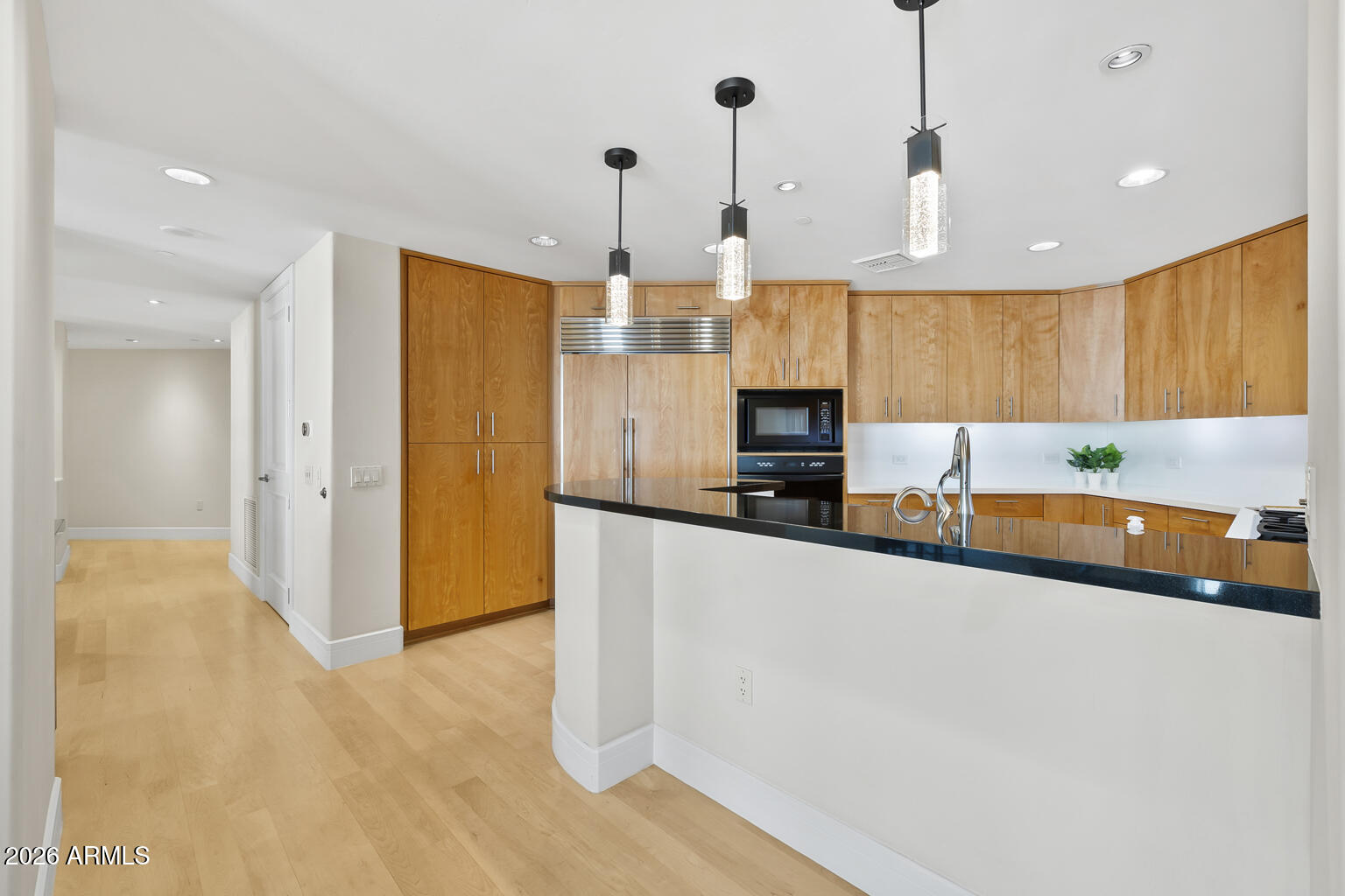 2402 East Esplanade Lane, Unit 704 Phoenix, AZ 85016 - Photo 15 of 42 a large kitchen with stainless steel appliances a large counter top a stove a refrigerator and a sink
