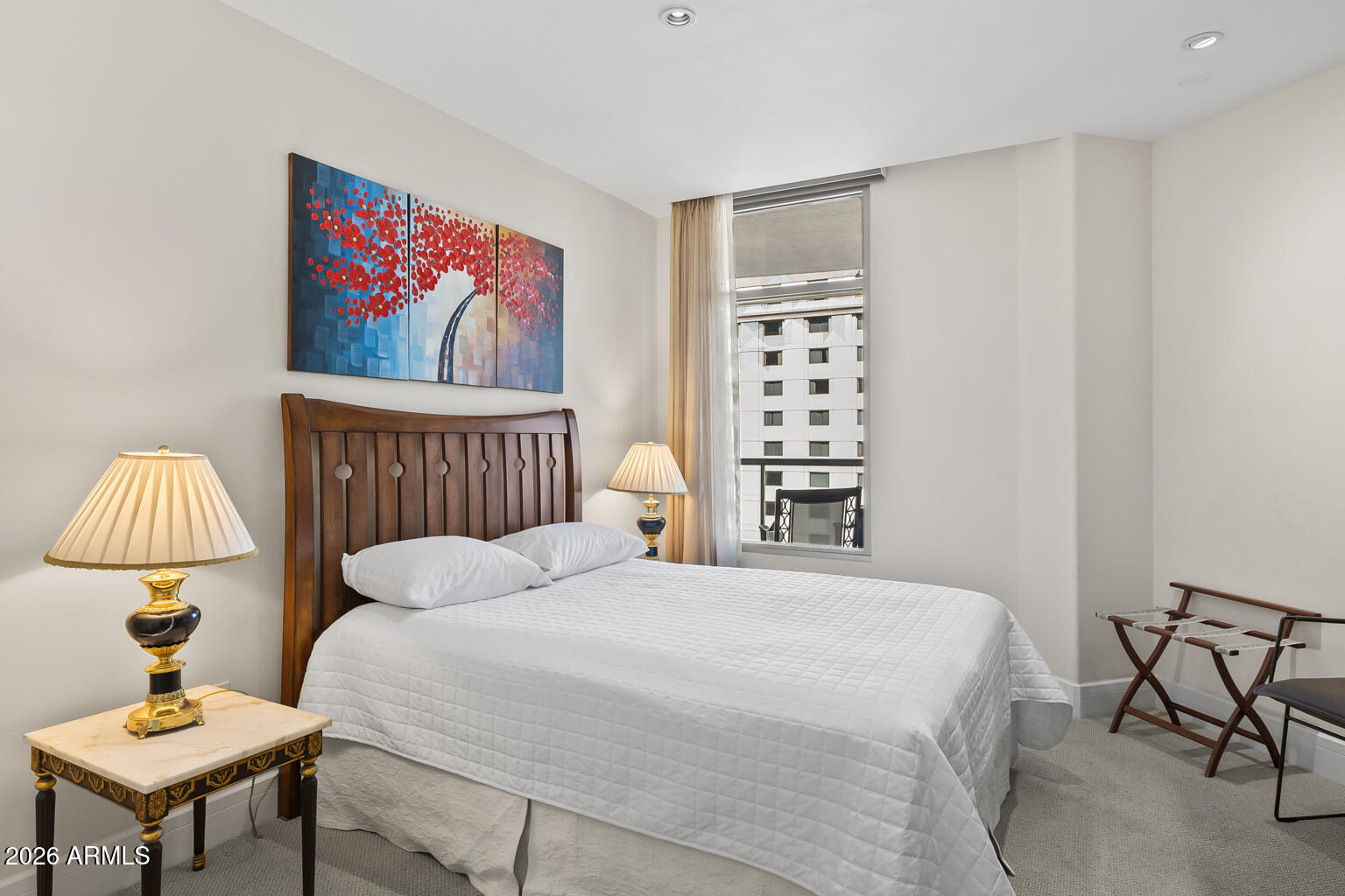 2402 East Esplanade Lane, Unit 704 Phoenix, AZ 85016 - Photo 19 of 42 a bedroom with a bed a rug and a wall painting