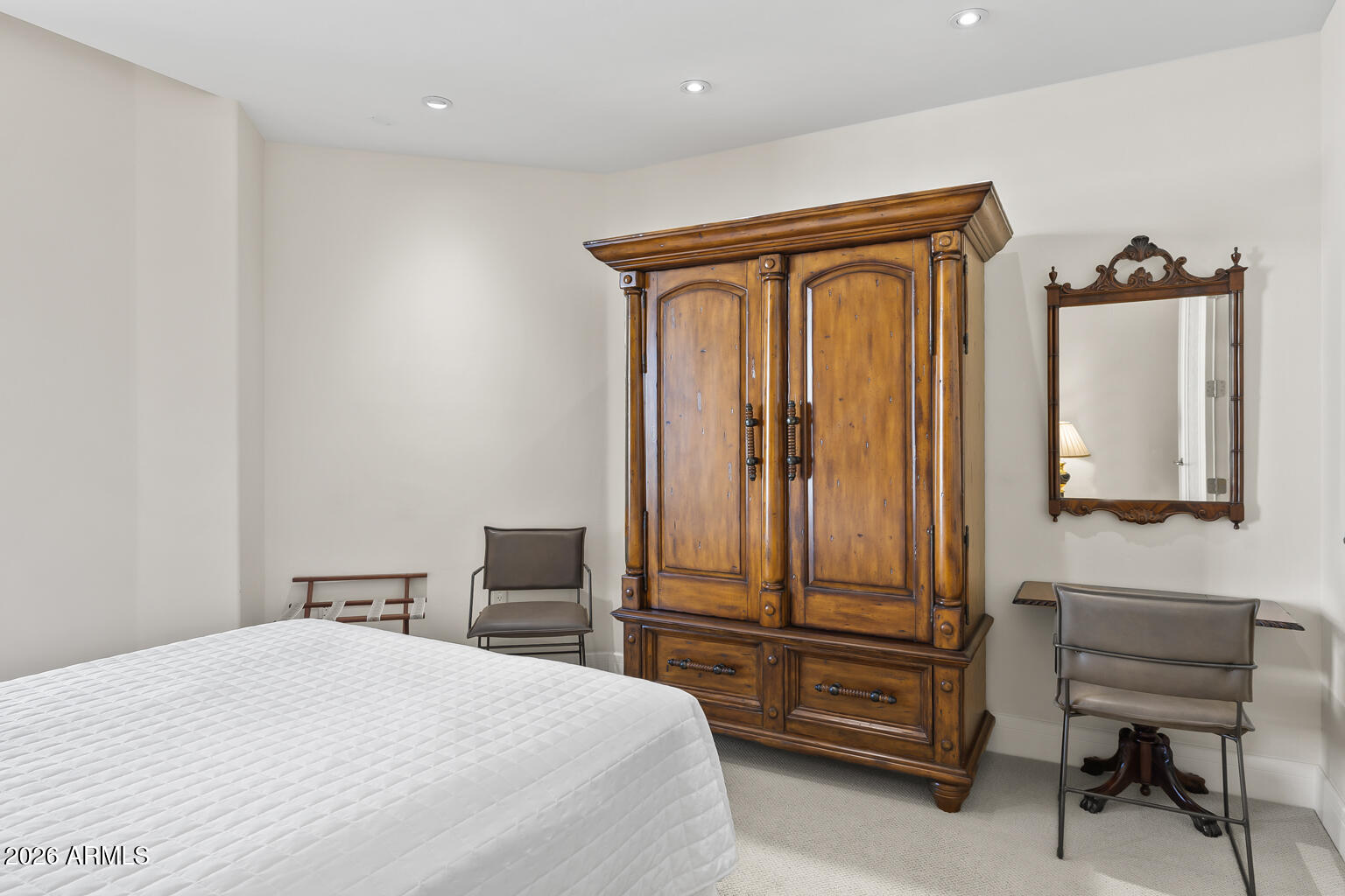 2402 East Esplanade Lane, Unit 704 Phoenix, AZ 85016 - Photo 20 of 42 a bedroom with a bed and chair