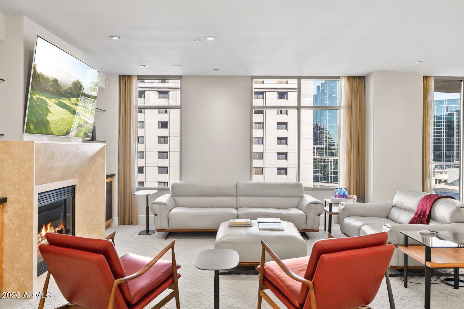 2402 East Esplanade Lane, Unit 704 Phoenix, AZ 85016 - Photo 7 of 42 a living room with furniture a large window and a flat screen tv
