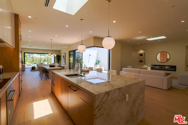 a large kitchen with stainless steel appliances lots of counter space and a sink