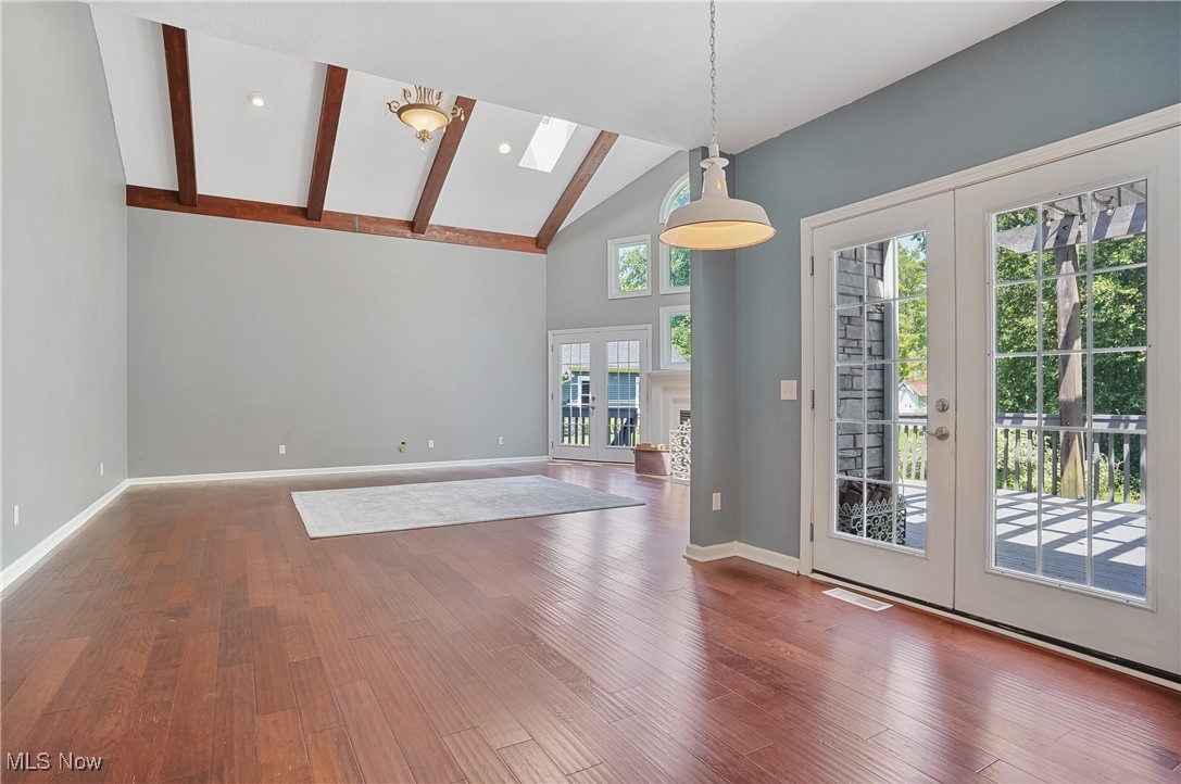 1453 Prospect Road Hudson, OH 44236 - Photo 13 of 50 Unfurnished dining area featuring high vaulted ceiling, french doors, wood finished floors, beamed ceiling, and a skylight