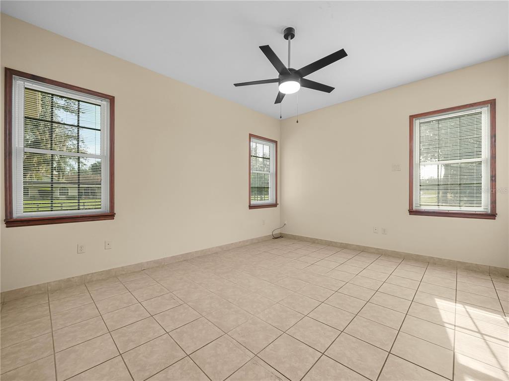 100 Reedy Creek Drive Frostproof, FL 33843 - Photo 11 of 36 a view of a big room with windows and chandelier fan
