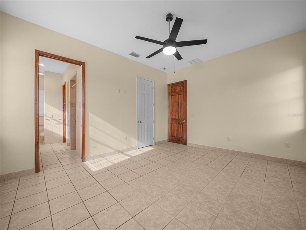 100 Reedy Creek Drive Frostproof, FL 33843 - Photo 12 of 36 an empty room to ceiling fan and entryway
