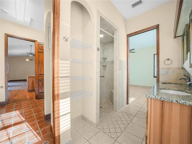 a bathroom with a granite countertop shower mirror and a sink