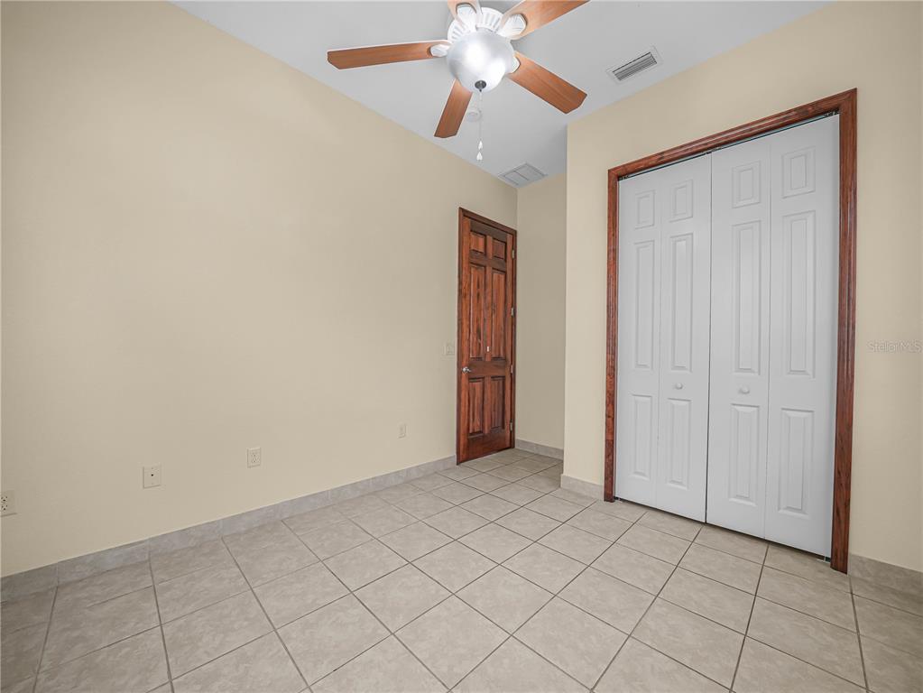 100 Reedy Creek Drive Frostproof, FL 33843 - Photo 17 of 36 a view of an empty room and chandelier fan