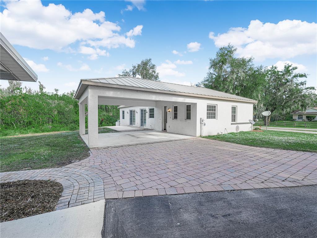 100 Reedy Creek Drive Frostproof, FL 33843 - Photo 25 of 36 a front view of a house with garden