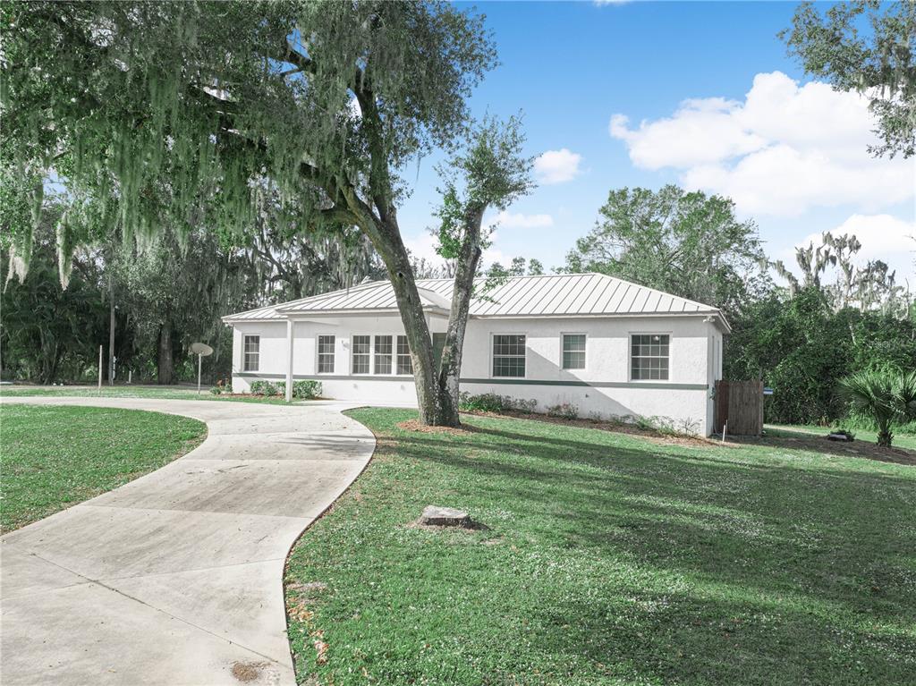 100 Reedy Creek Drive Frostproof, FL 33843 - Photo 28 of 36 a front view of a house with a garden