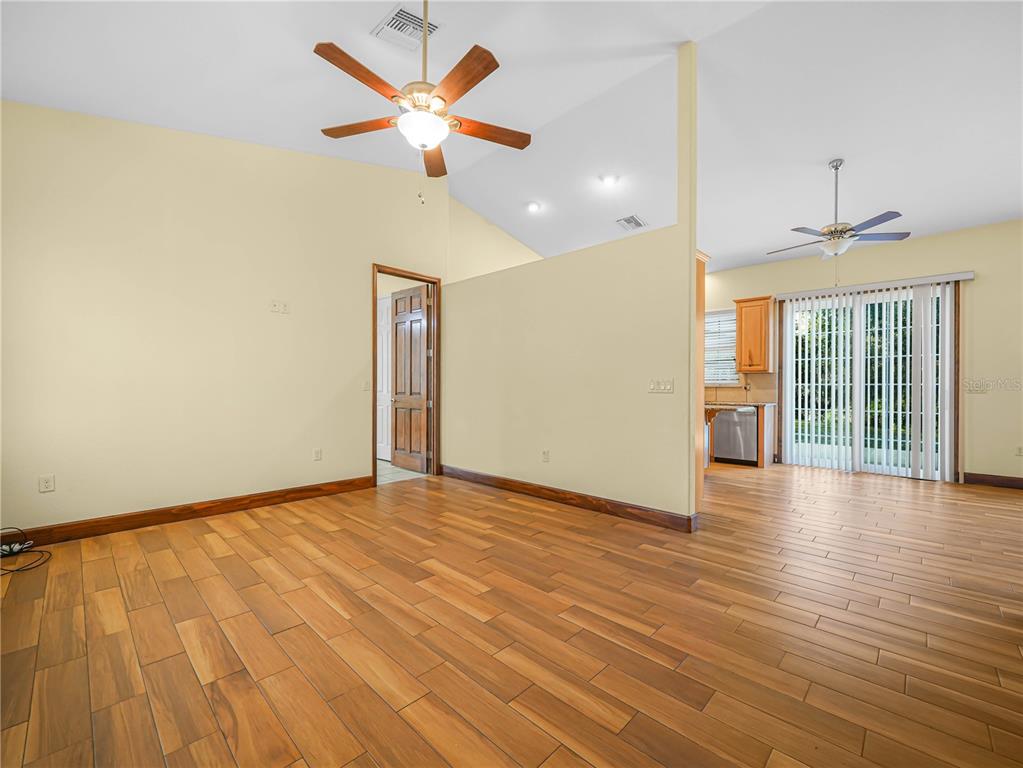 100 Reedy Creek Drive Frostproof, FL 33843 - Photo 4 of 36 a view of an empty room with glass door and a chandelier fan