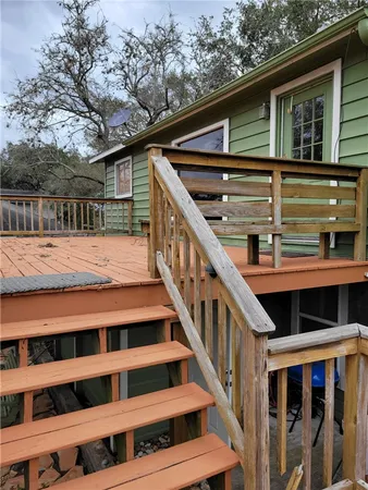 a view of wooden house with a large window