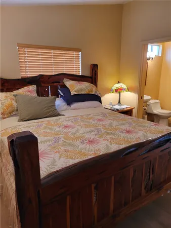 a bedroom with a bed and a dresser