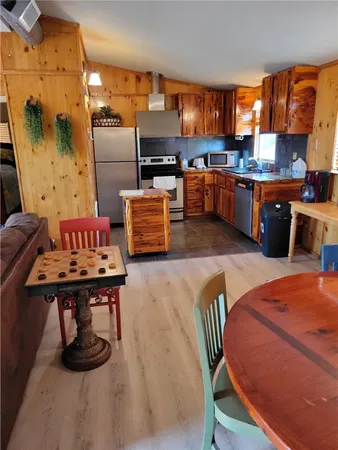 a living room with stainless steel appliances kitchen island granite countertop furniture and a kitchen view