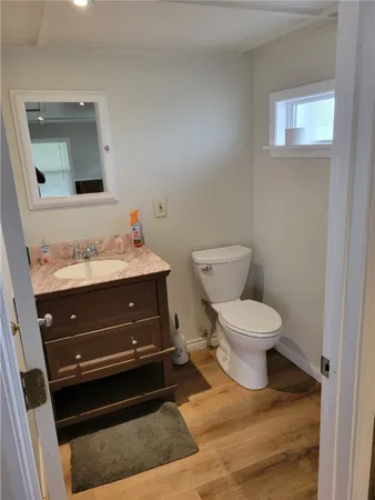 a bathroom with a toilet sink and mirror