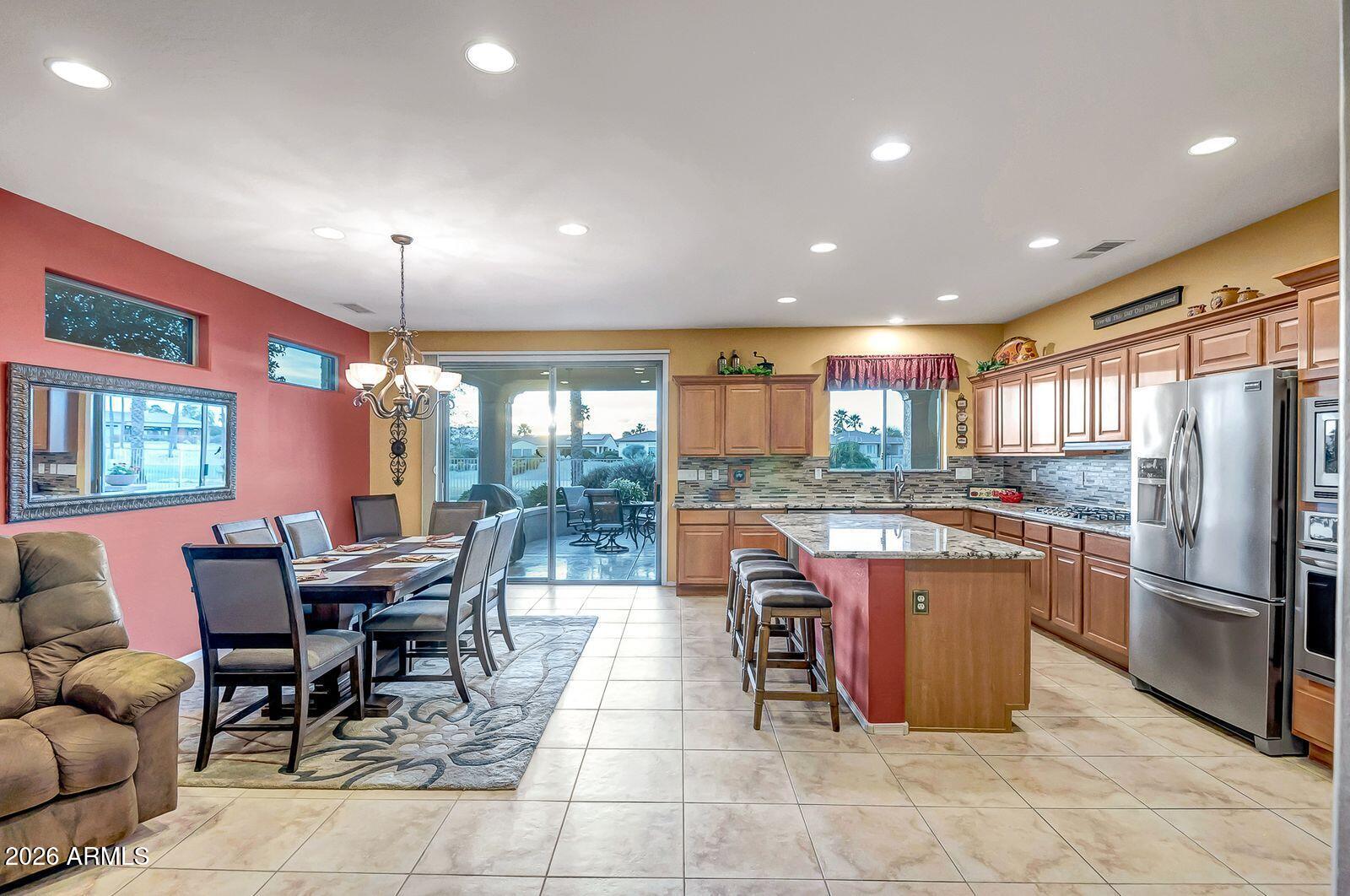 19848 North Rawhide Way Surprise, AZ 85387 - Photo 11 of 61 a kitchen with stainless steel appliances granite countertop a table and chairs
